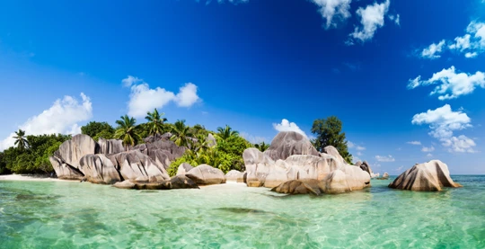 In the Seychelles, Anse Source d'Argent is La Digue's most famous beach, surrounded by large granite boulders and fringed by coconut palms.
